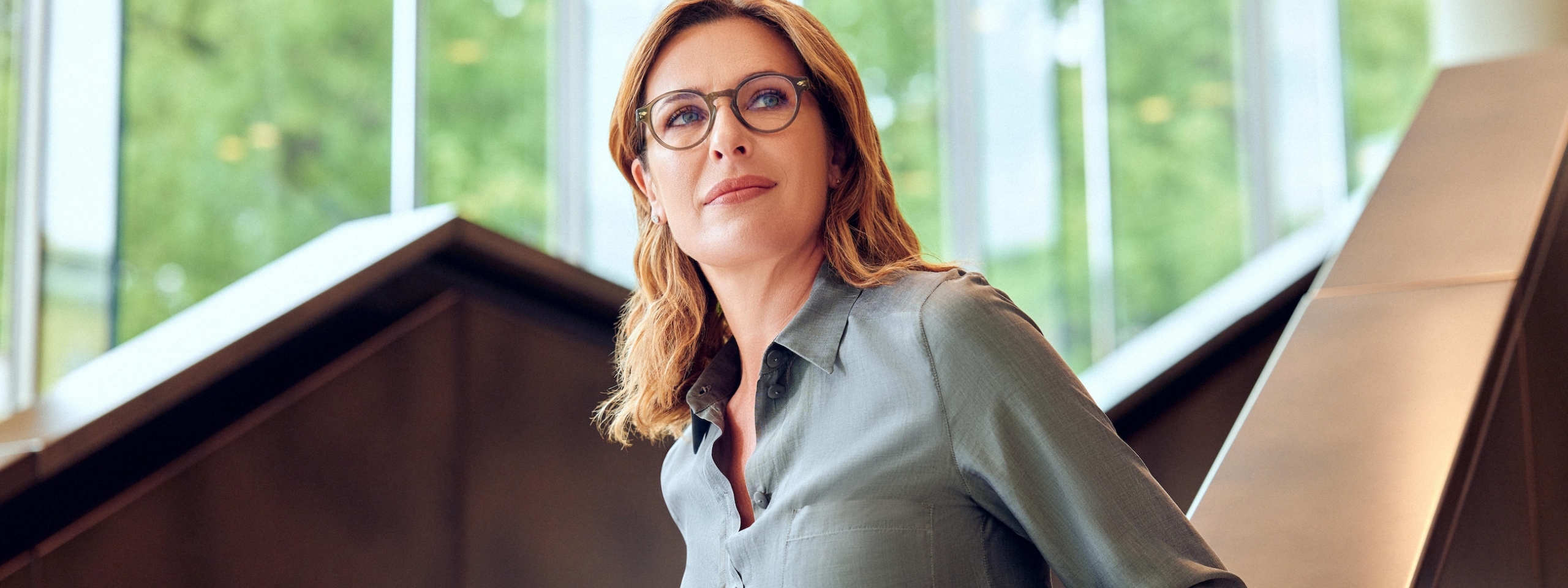 Frau mit Brille geht Treppe hinunter